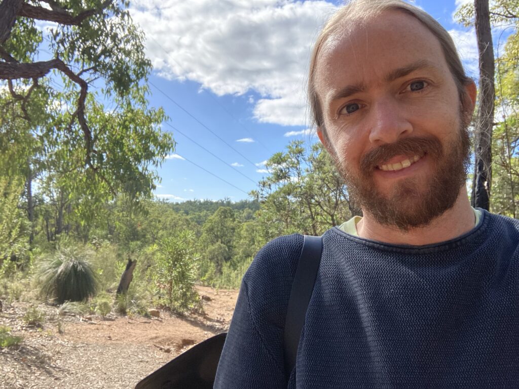 A photo (selfie) of me standing in front of Australian bushland